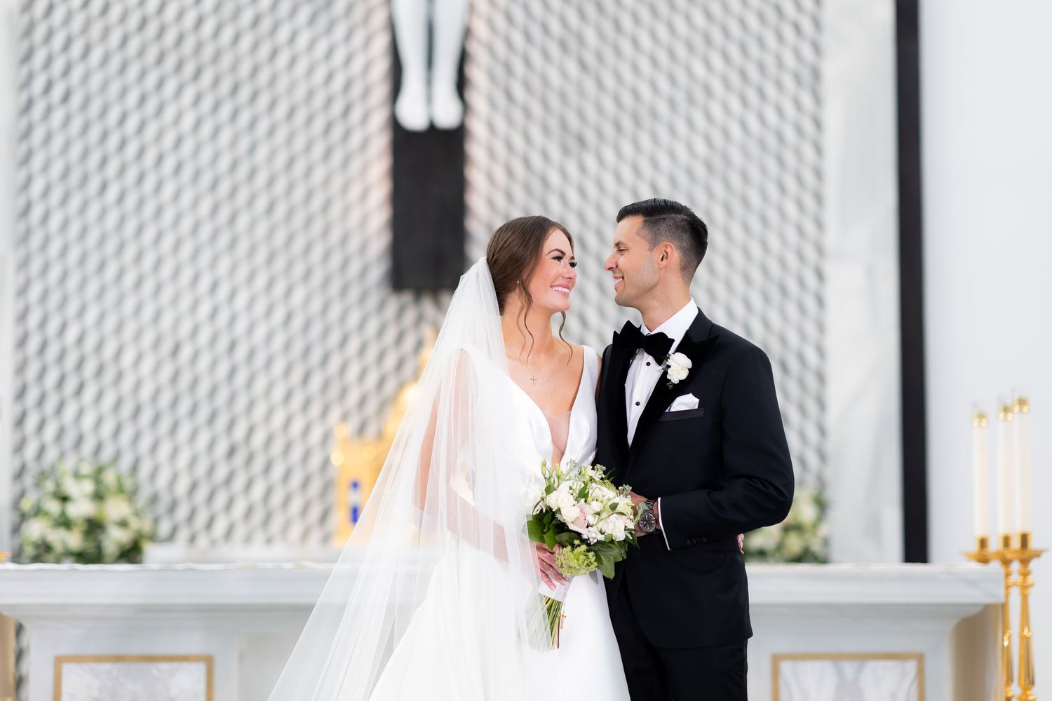 Wedding couple shares a romantic kiss during their ceremony.