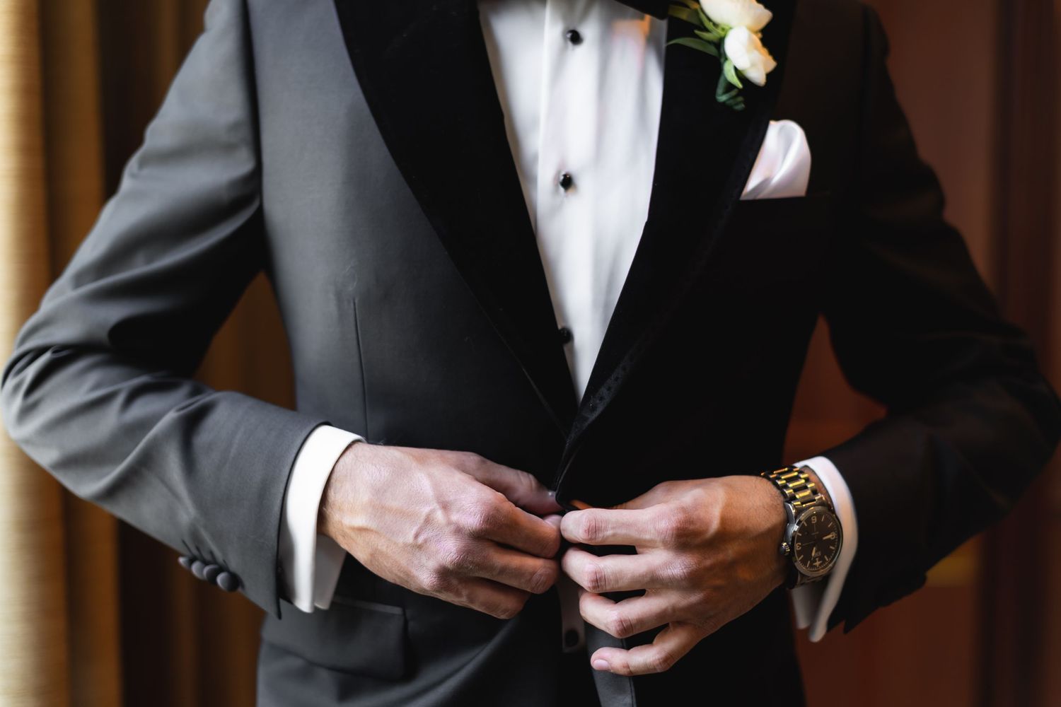 Formal wear details showing white pocket squares and black lapels in natural light.