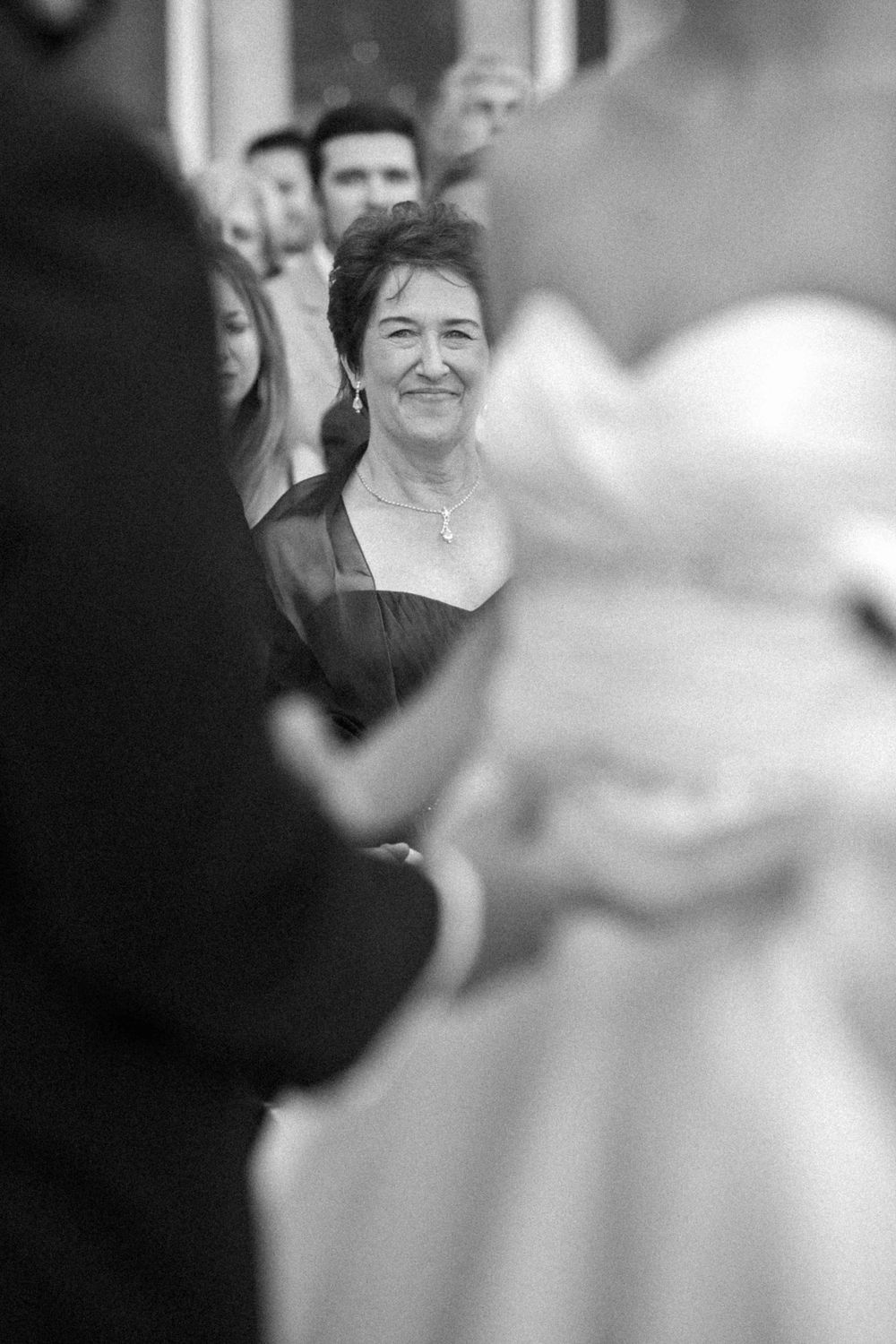 A collection of black and white wedding photos showing candid moments and expressions during a celebration.