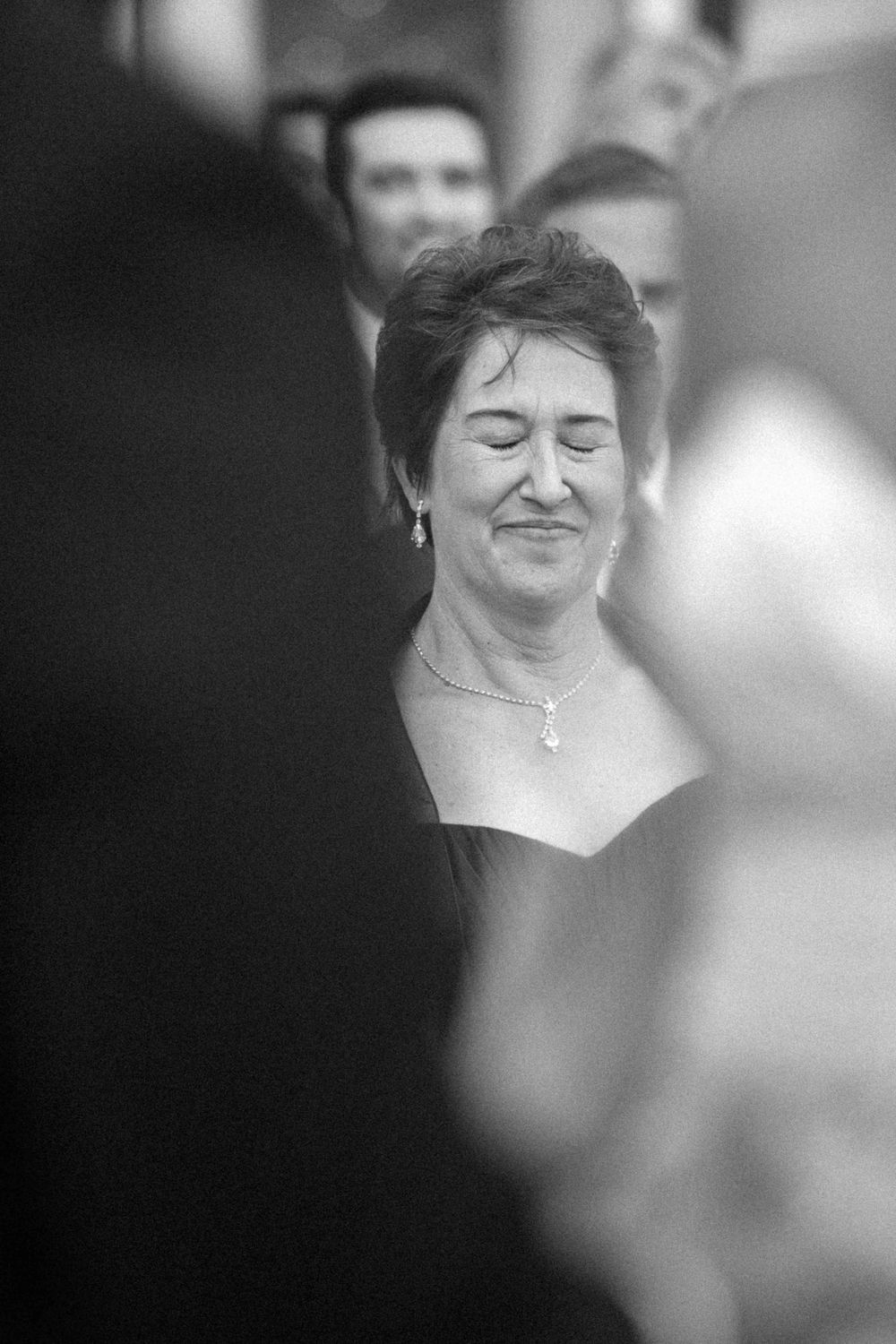 A series of black and white close-up photos show a person with closed eyes and gentle smiles in various poses.