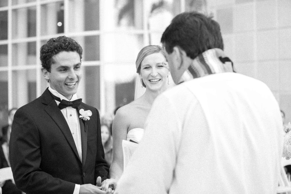 A black and white wedding photo montage showing happy moments between couples and guests at a celebration.