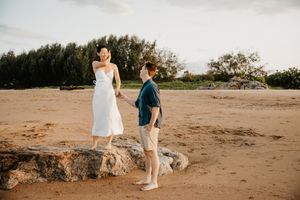 engagement couple at sunset holding hands at Saunders Beach in Townsville