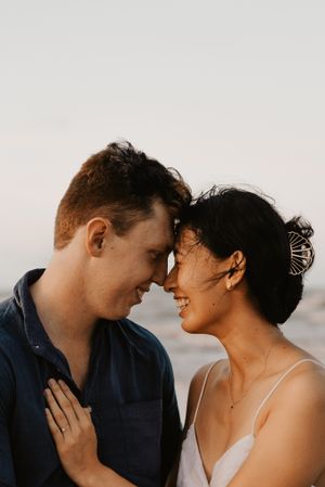 engagement couple showing love at sunset at Saunders Beach in Townsville