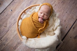 newborn in neutrals and mustard