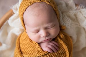 newborn baby in mustard