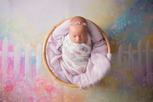 newborn baby in a colourful garden