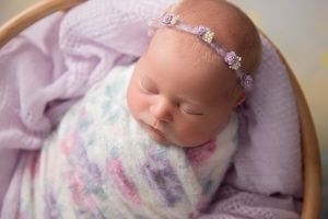 newborn baby in delicate purple