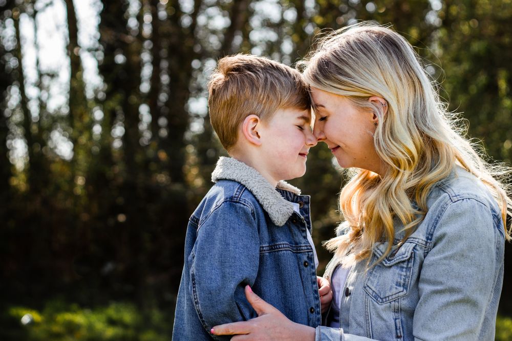 In a field in Havant a Mum kneels nose to nose with her Son in the morning sunlight.