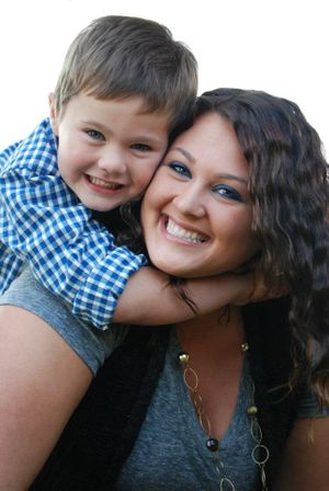 A joyful portrait showing warm smiles and close embrace against a light background.