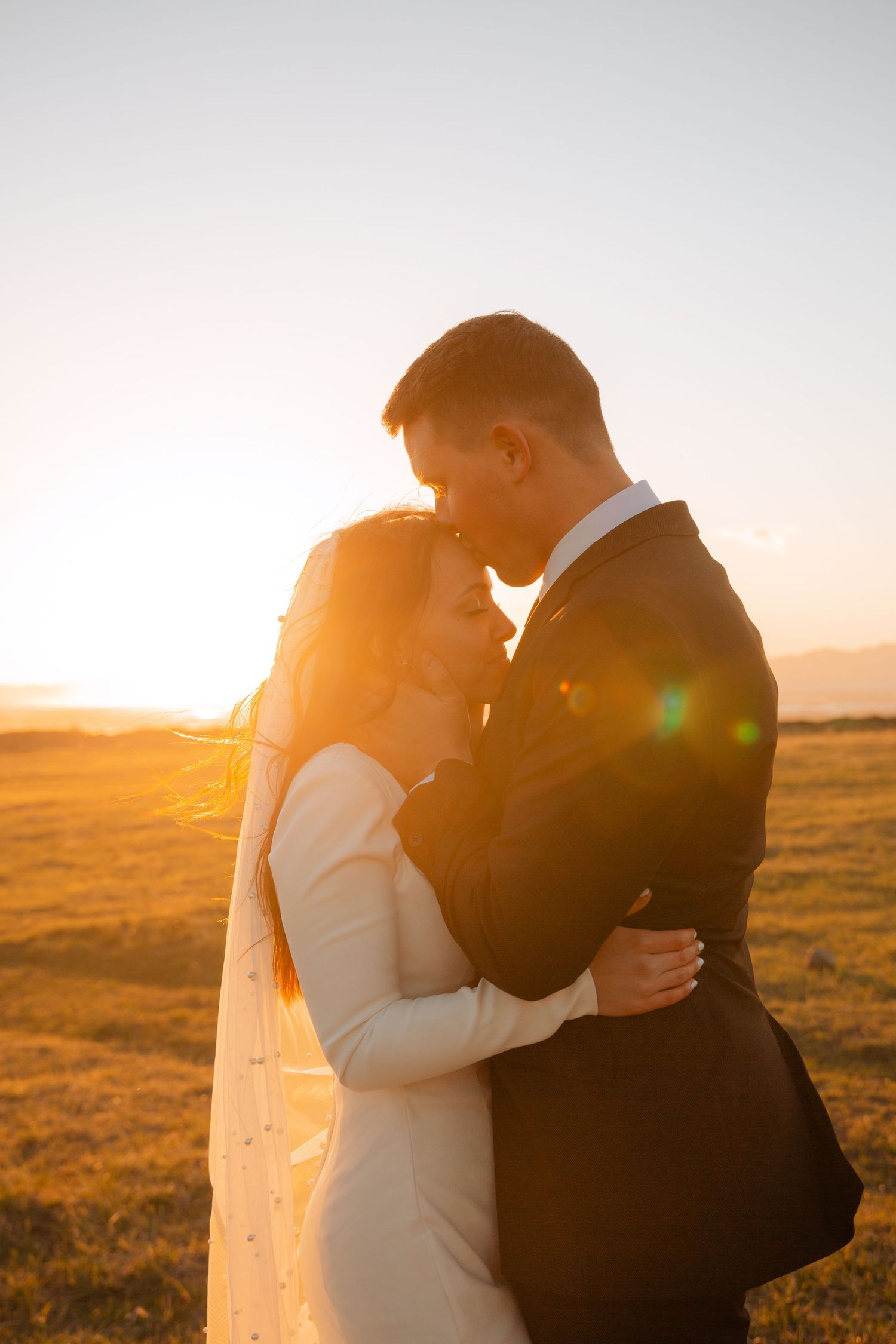 couple kissing in the light from sunset at tunnel springs park in salt lake county