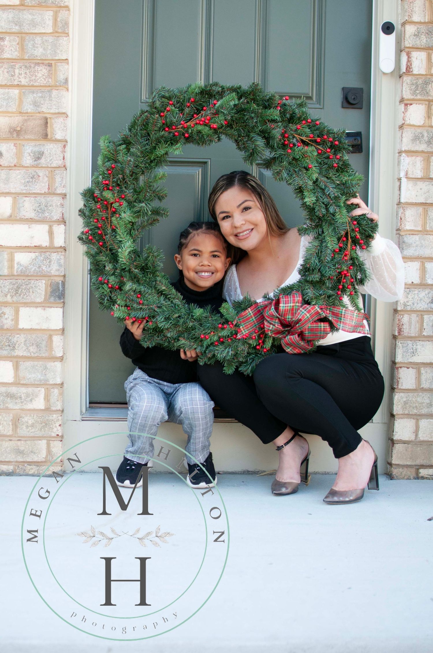 Mom and young son holding wreath