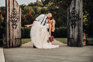 Groom dips bride pose