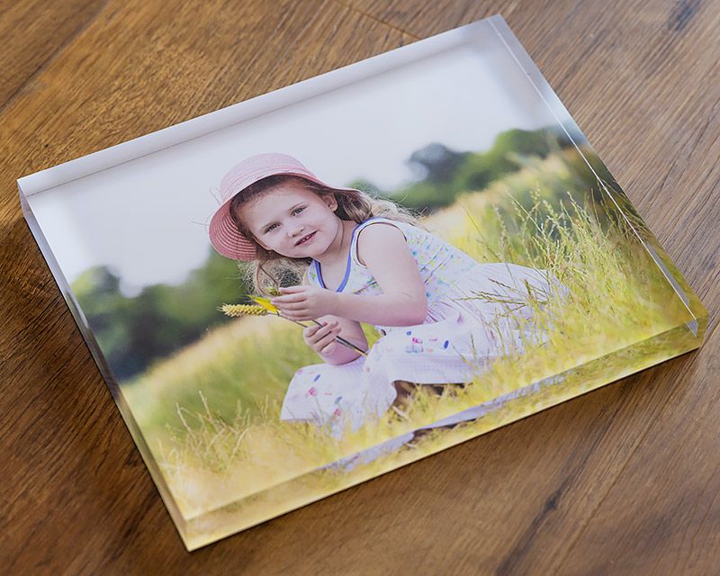 A photographic print on wood showing a summer meadow scene.