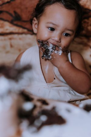 A messy cake smash photo sequence showing a small child getting covered in frosting and cake.
