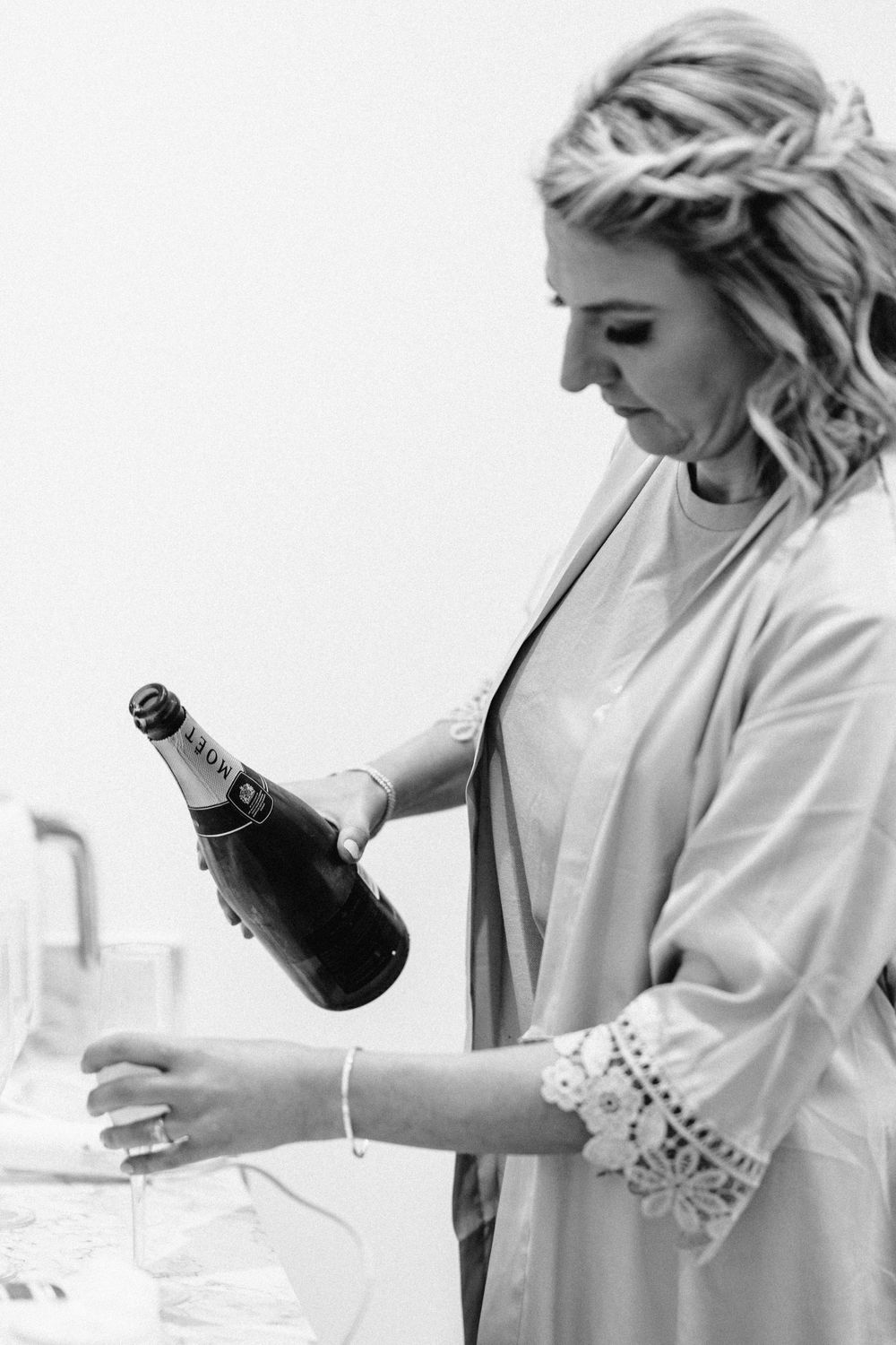 Sequence of someone pouring champagne into glasses during a celebratory moment.