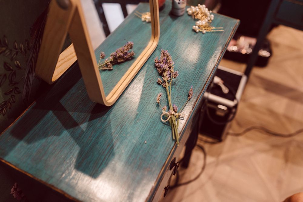 A distressed turquoise wooden table with vintage decor elements.