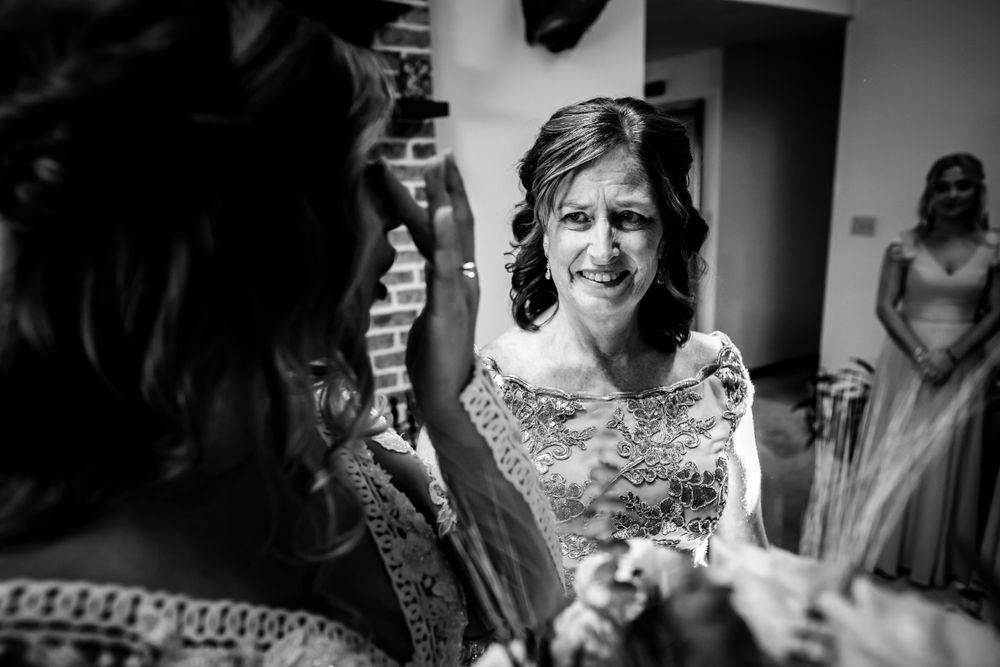 Black and white candid shots of wedding party preparations indoors.