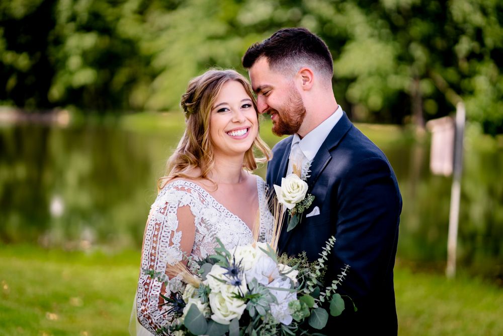 Wedding couple shares intimate moments in a lush garden setting with natural greenery.