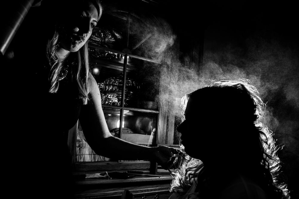 Artistic black and white photography with smoke effects and dramatic side lighting.
