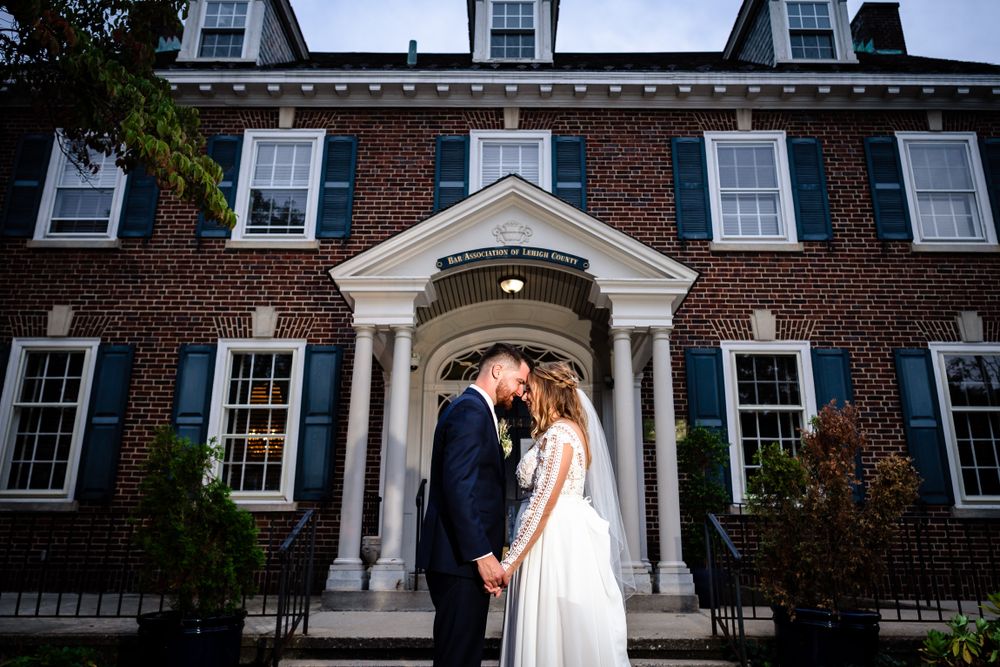 Elegant architectural shots of a brick wedding venue with white trim and windows.
