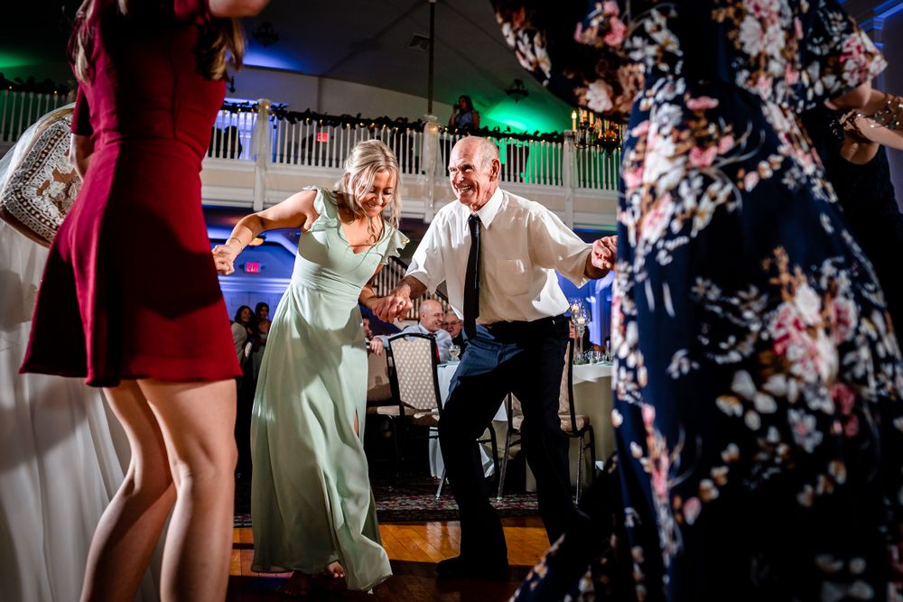 Energetic dance floor scenes at a wedding reception with colorful lighting effects.