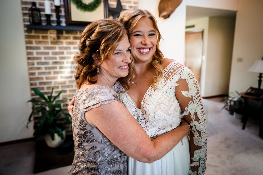 Bridesmaids in mint green dresses sharing a joyful moment together.
