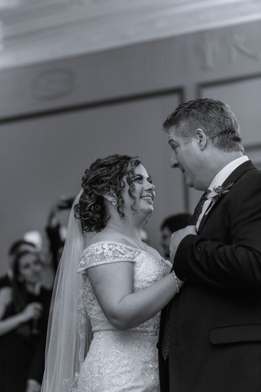 Black and white wedding photo capturing an intimate moment during the ceremony.