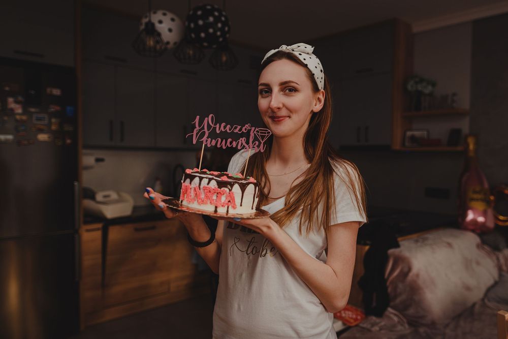 Celebratory indoor party scene with pink decorations and gift-opening moments.