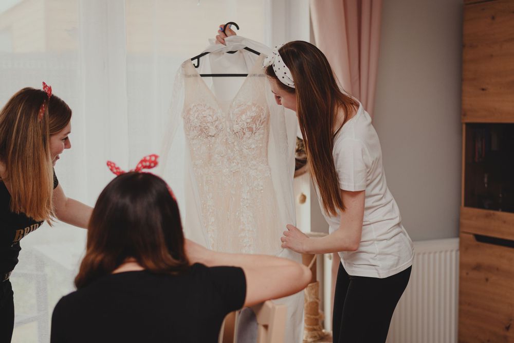 Group gathering in a cozy indoor setting with white decor and soft lighting.