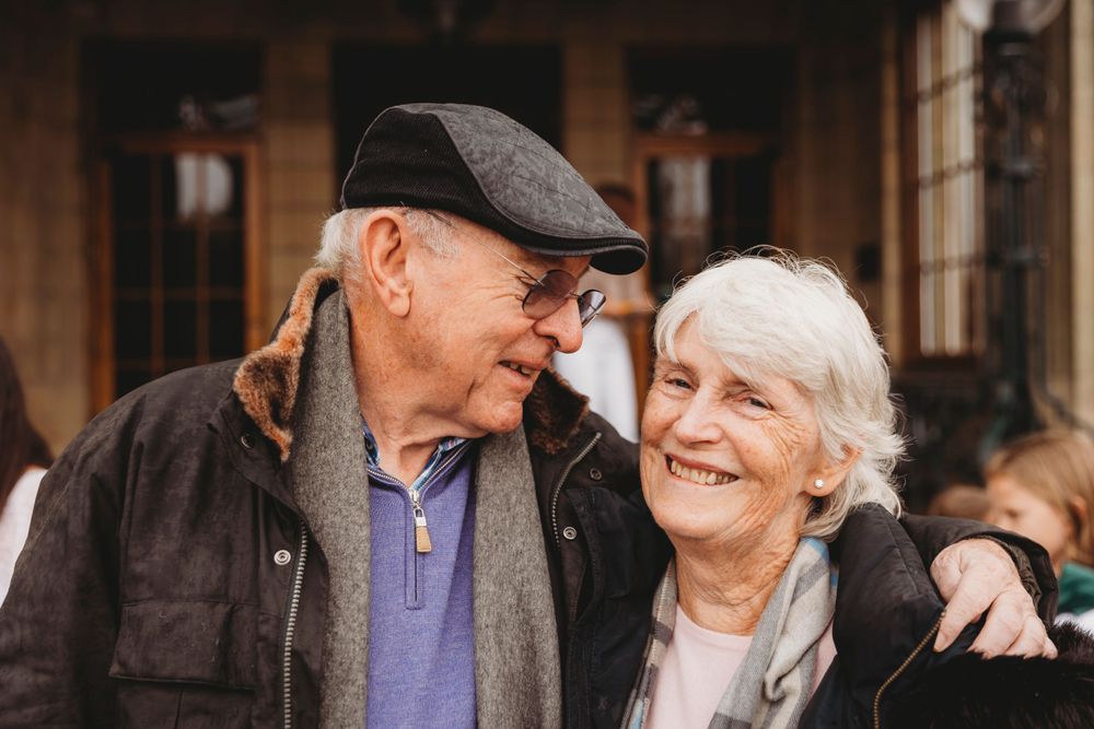 Elderly couple sharing a tender moment of laughter together.