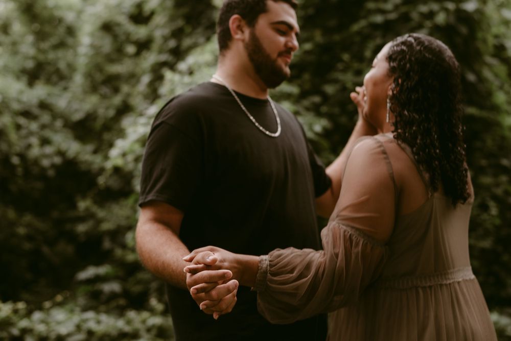 A couple holding hands and sharing a joyful moment in nature.