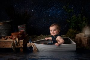 Nighttime scene with miniature boat setup against starry backdrop.