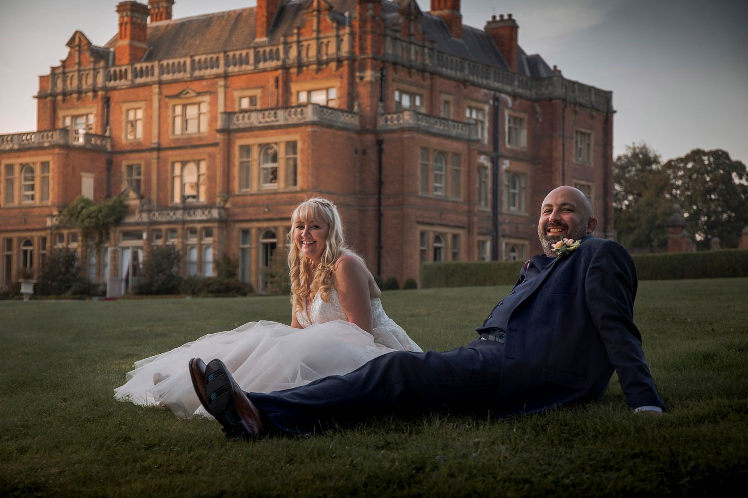 bride and groom sat relaxing in front of rossington hall doncaster evening laughter happy ever after
