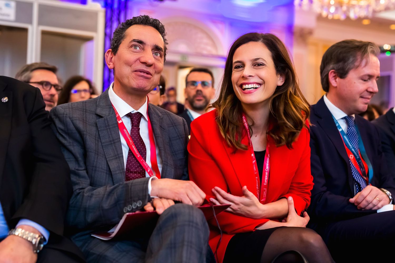 Attendees engaged in conversation during a formal conference event.