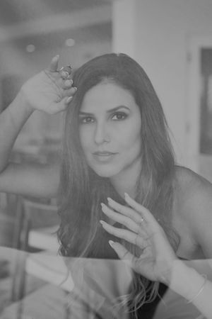 Black and white portrait with artistic lighting and reflective elements.