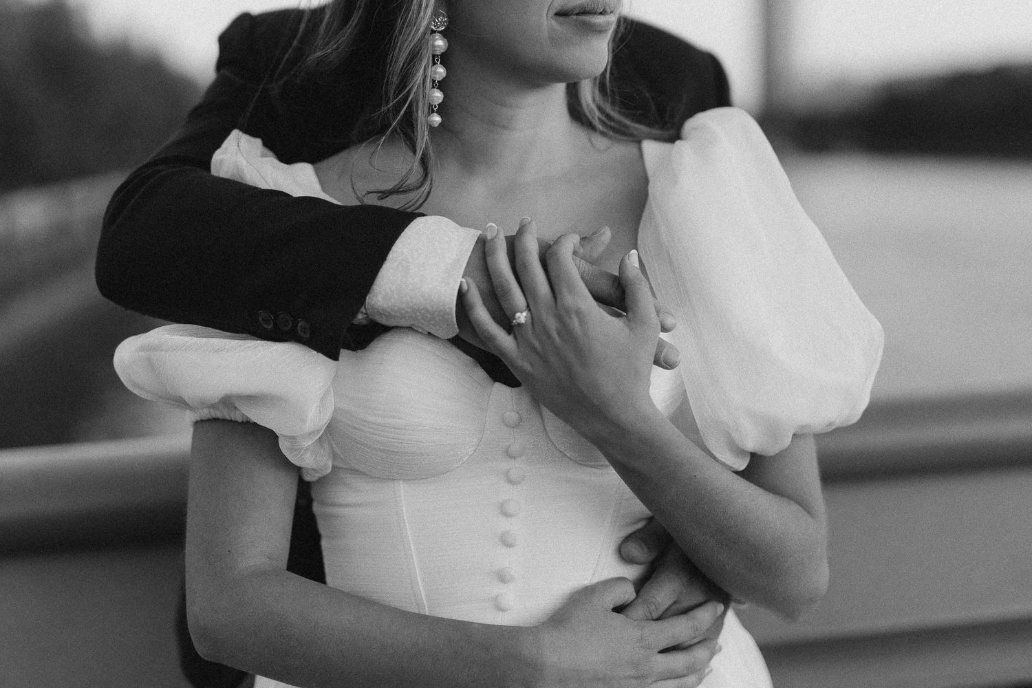 Couple is holding hands showing off the engagement ring during their photoshoot in London