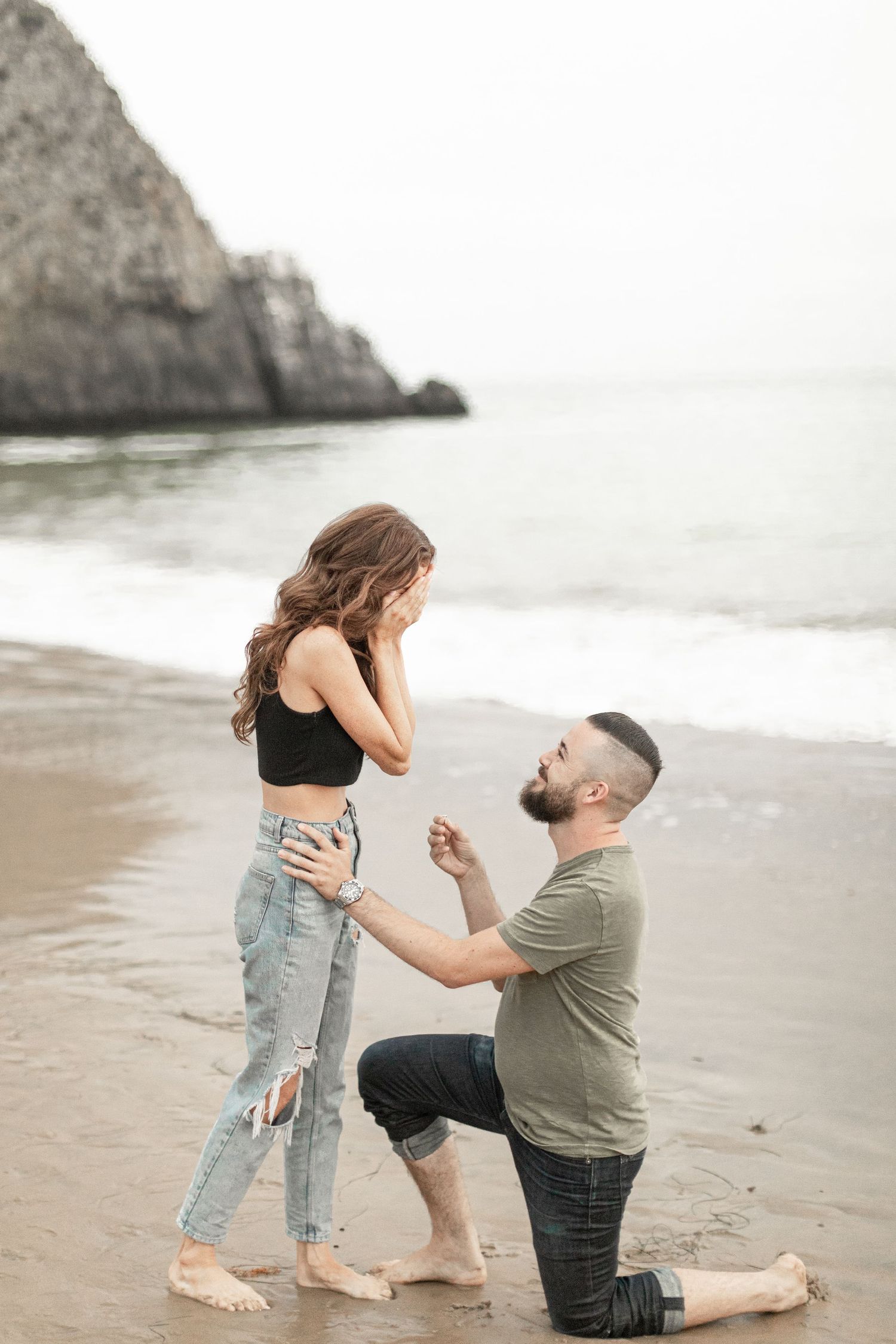 young couple engagement next to ocean in laguna beach california