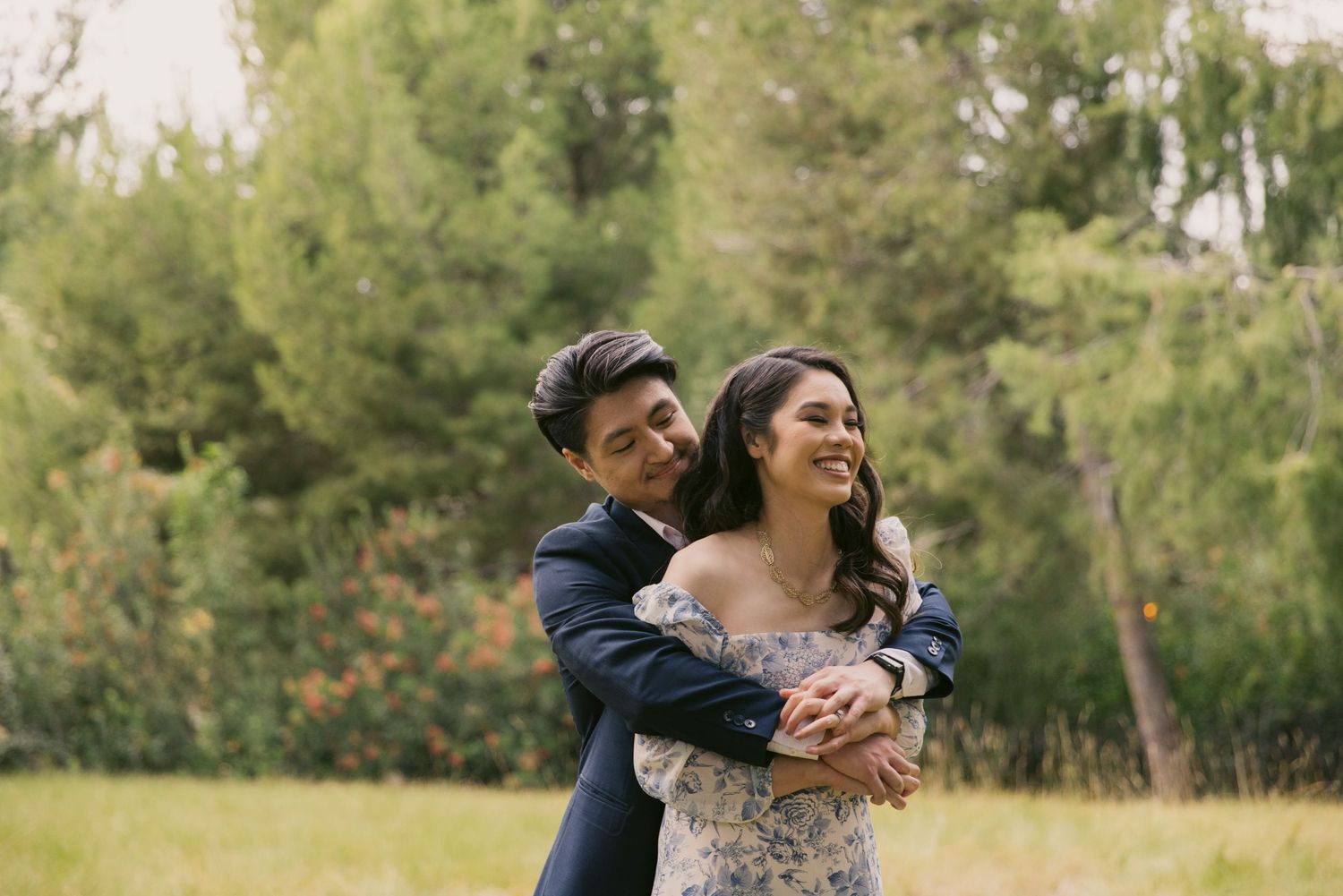 Sweet candid moment between couple during outdoor spring photoshoot.
