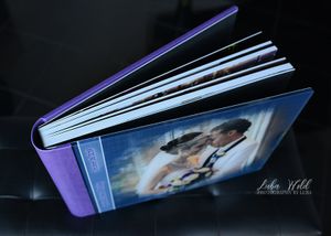spokane bride & groom wedding book showing strong binding purple leather back and glass cover photographer luba wold