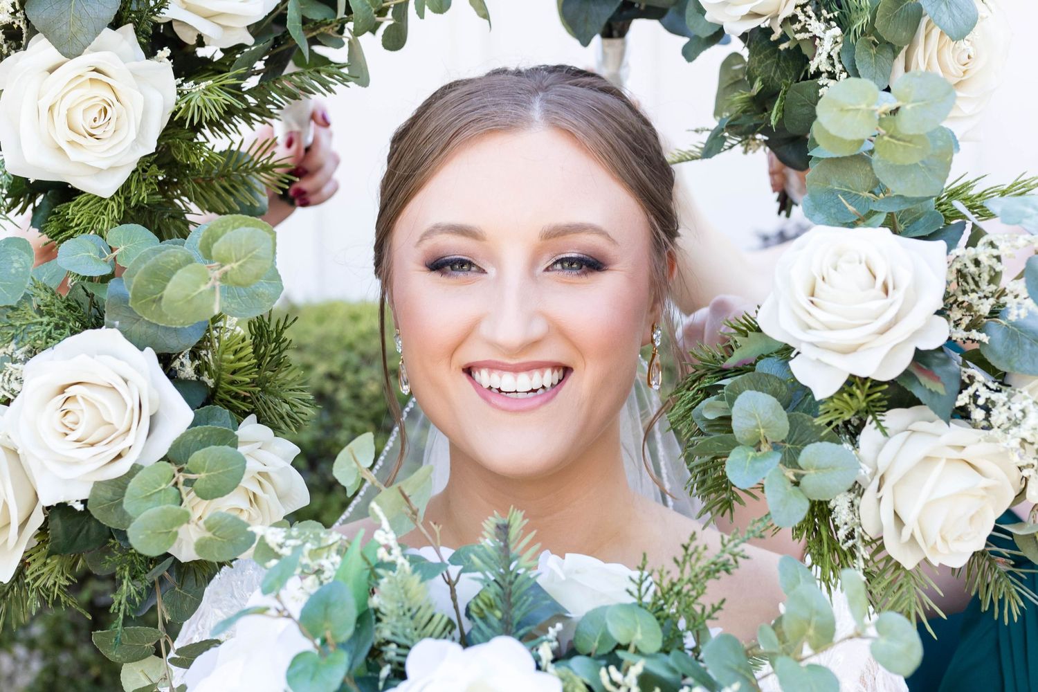bride with bouquets around her head
