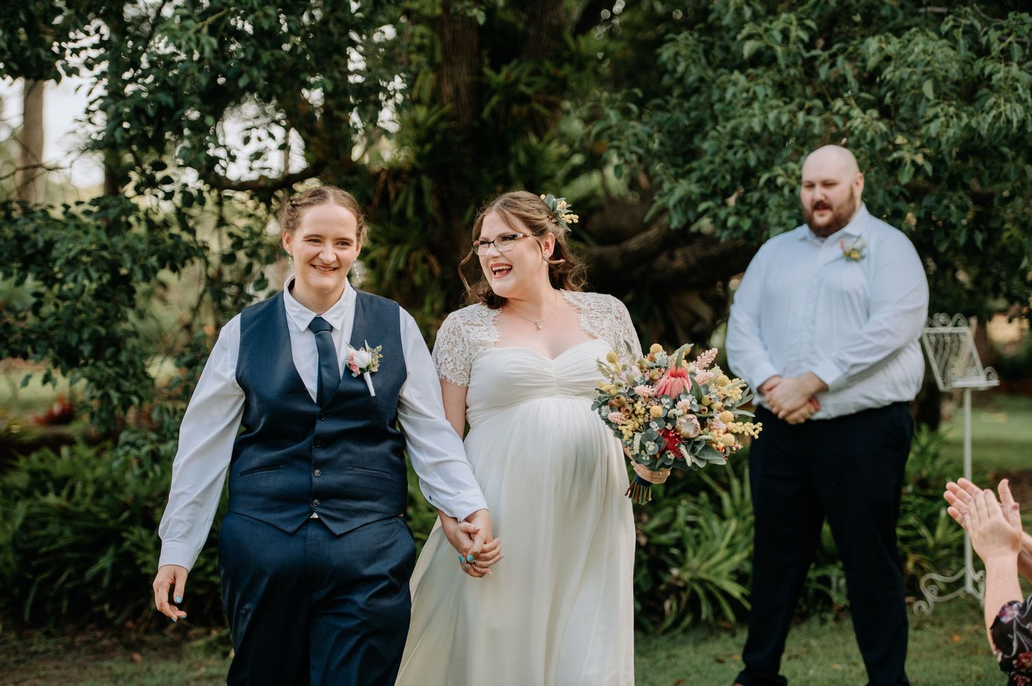 A joyful wedding celebration moment captured in a lush garden setting.