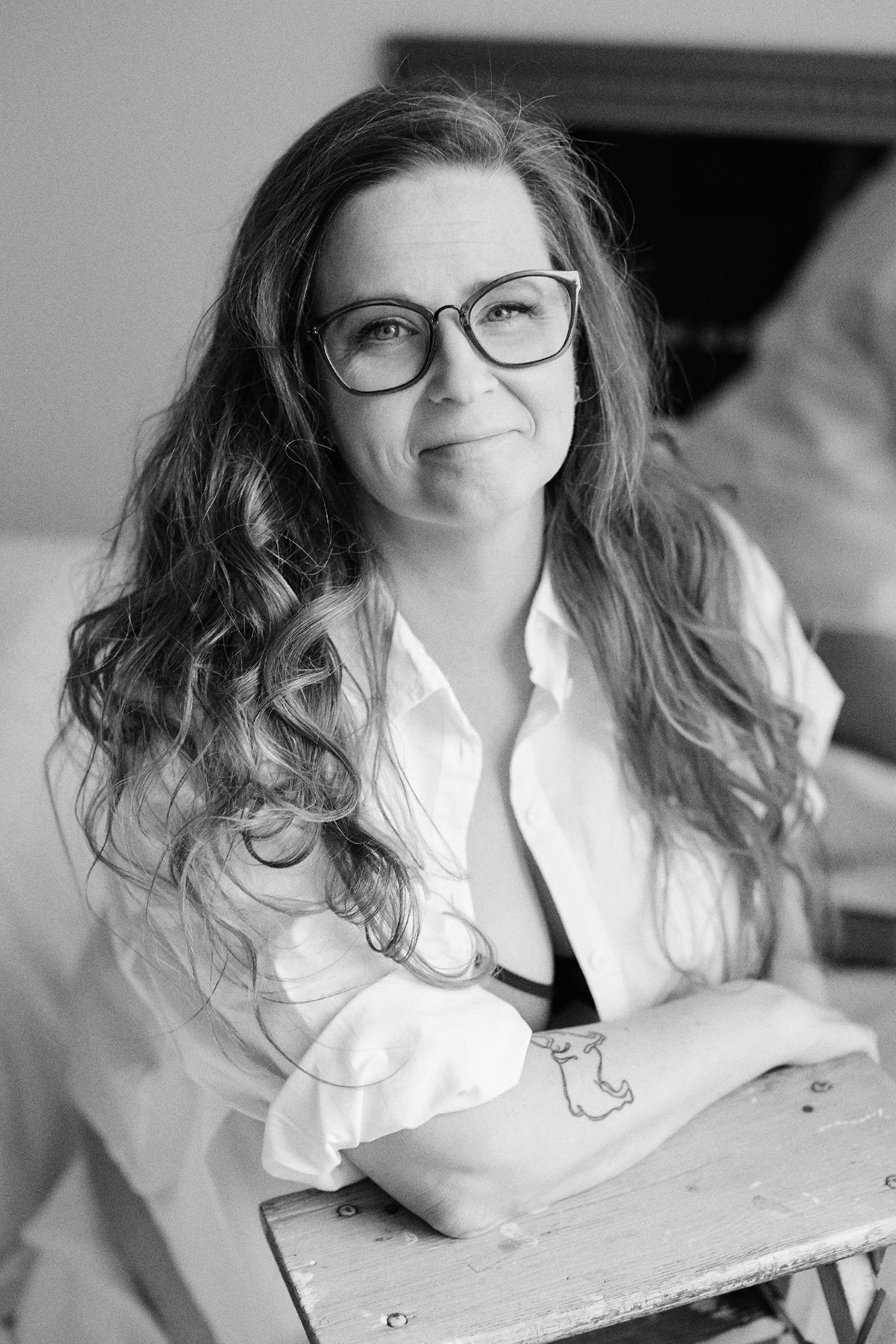 Black and white portrait series showing a woman in glasses and white shirt smiling warmly.