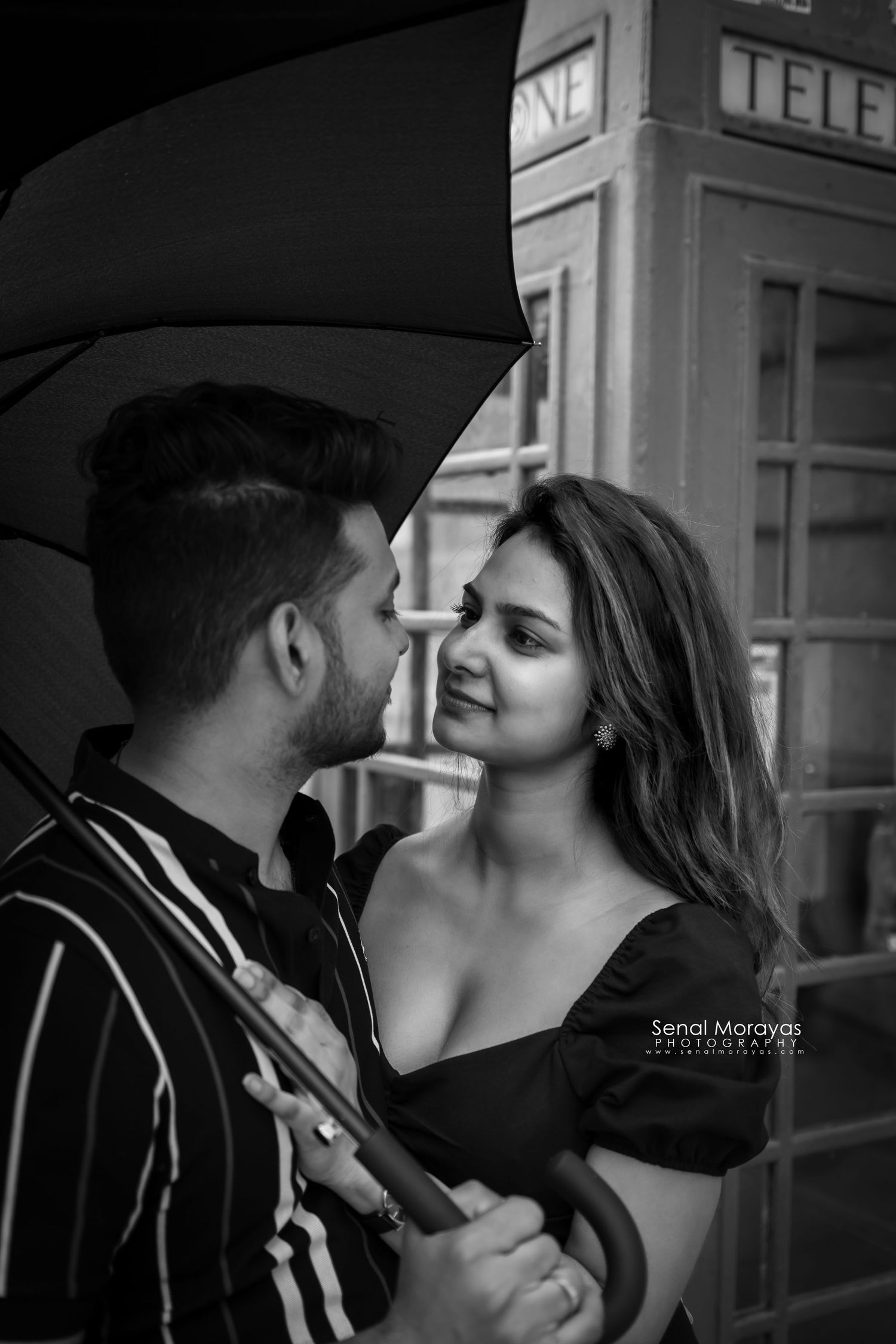 Black and white artistic portrait series showing intimate moments near a telephone booth.