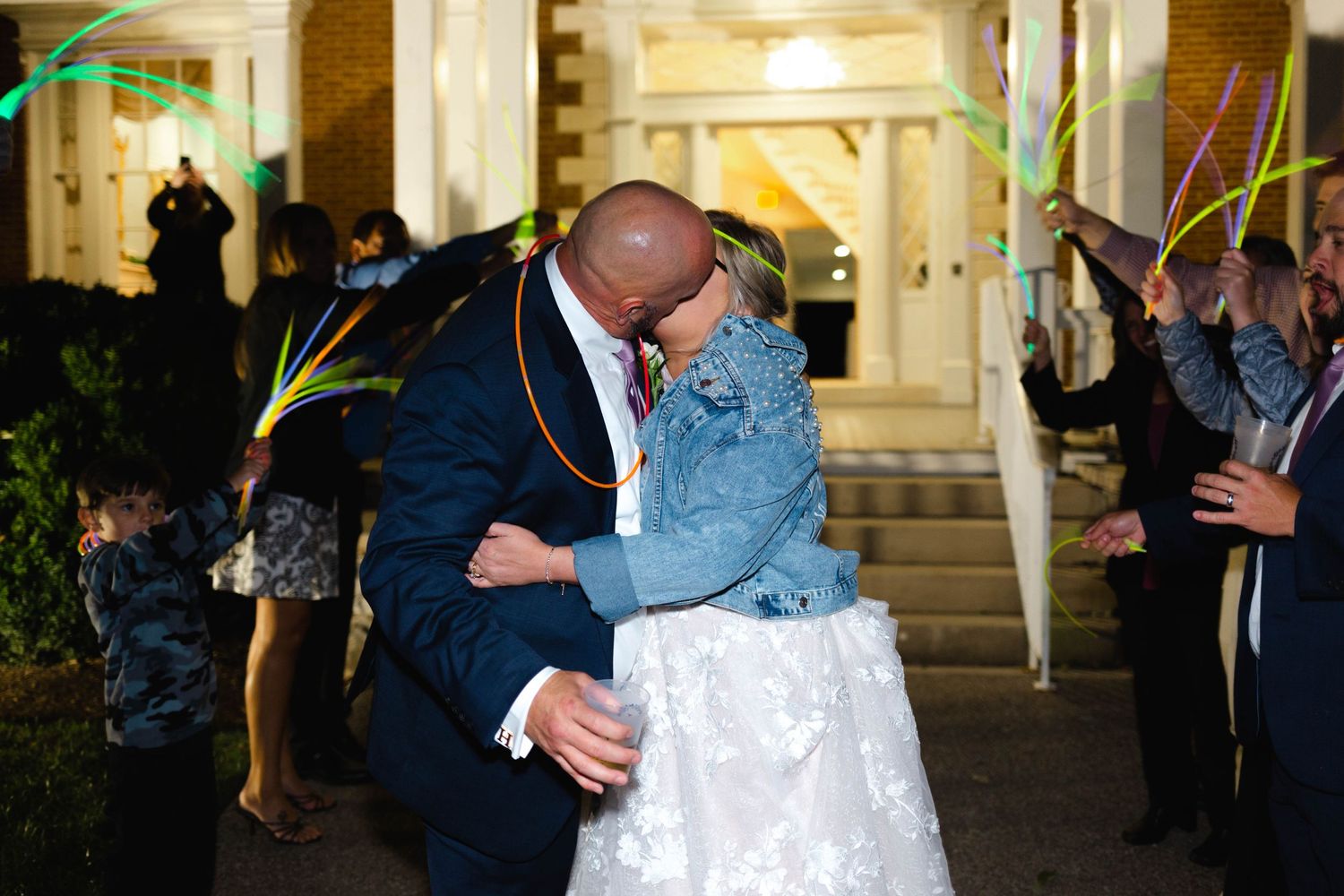 Couple sharing romantic dance moment at their wedding reception under festive lighting.