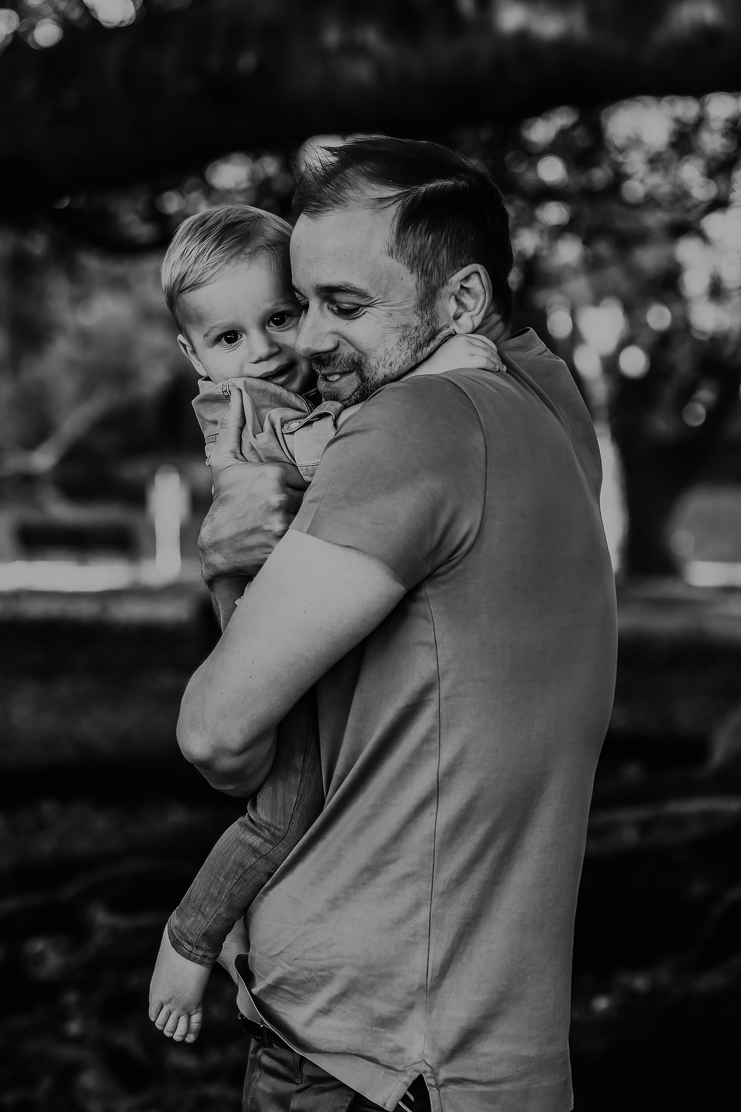 Black and white candid photo of loving parent and child bonding moments.