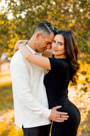An intimate moment between a couple captured in warm evening light.
