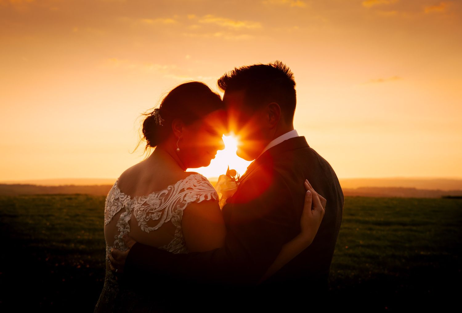 sunset wedding photographer capturing a special moment as the couple watch the sunset together