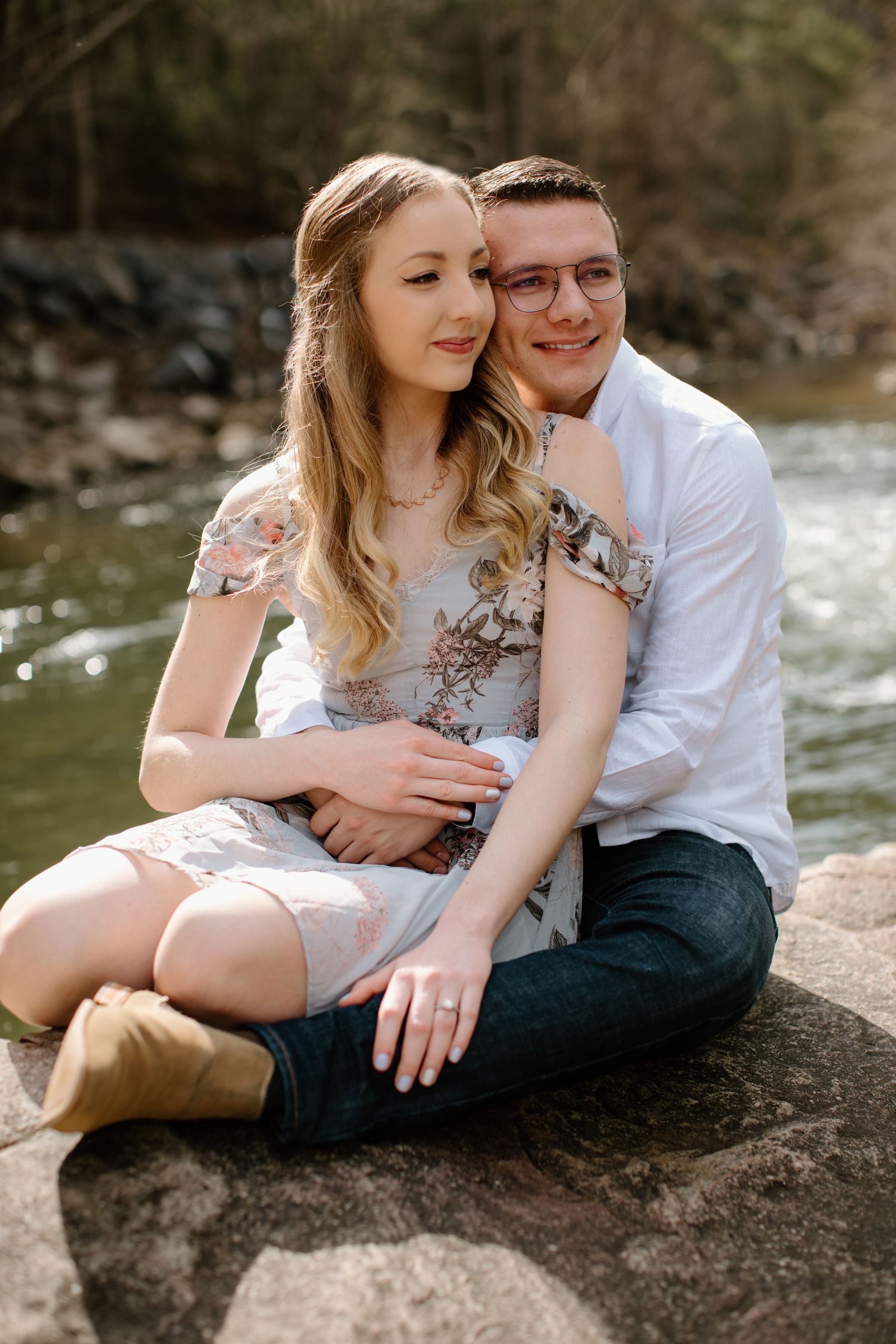 Intimate couple portrait session on rocks by flowing water.