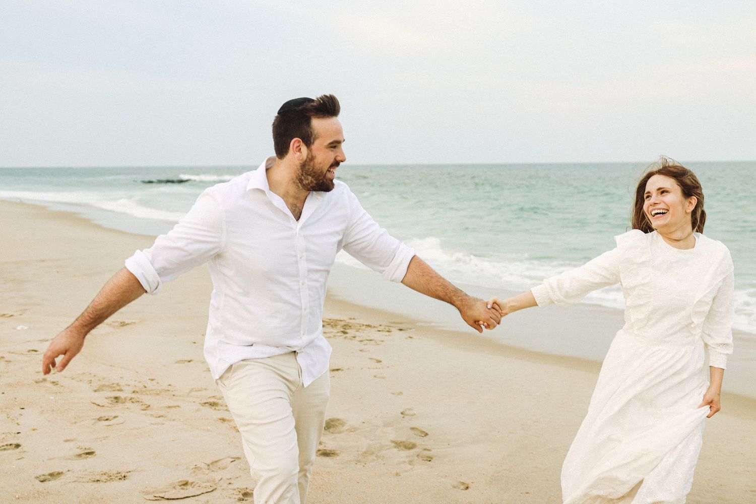 couple holding hands, captured naturally by a professional photographer