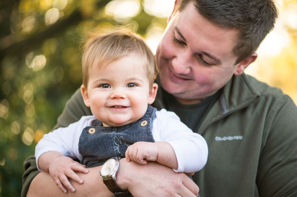 Photo of a daddy and his 11 month old son during an outdoor newborn photography session in Surrey